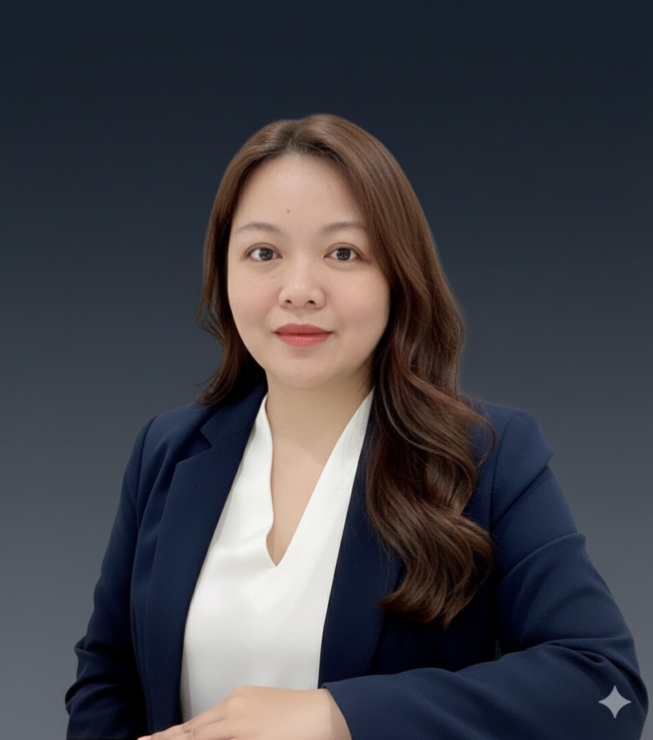 smiling woman wearing red, black, and gray plaid blazer