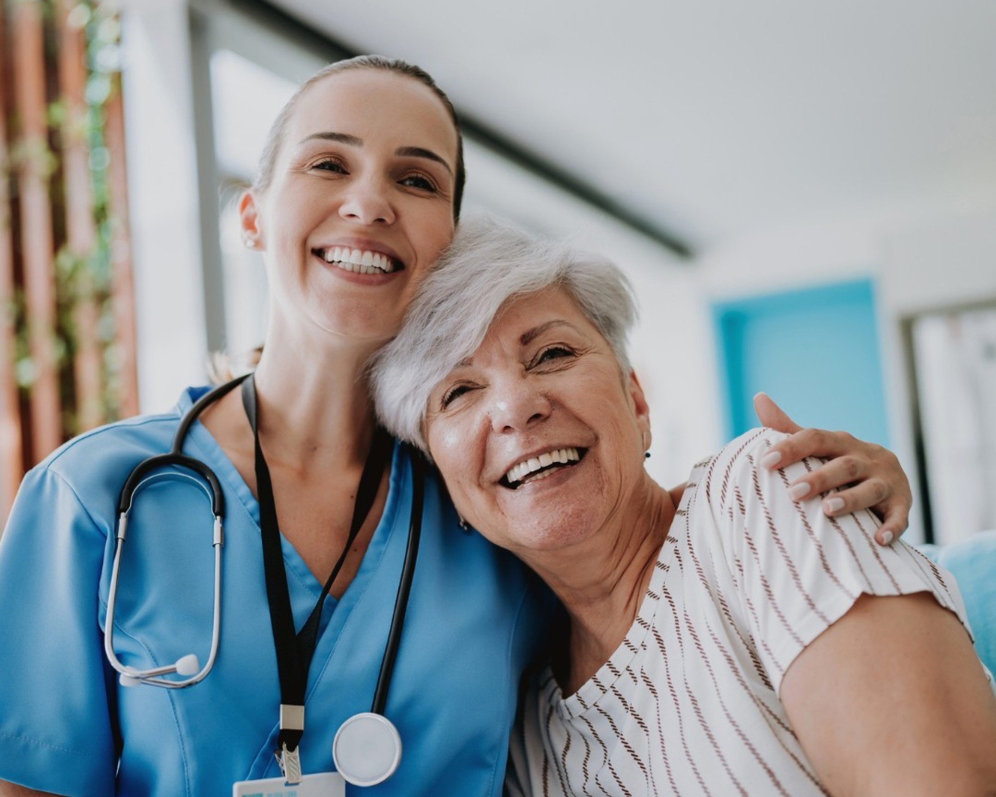 Medical doctor and patient both smiling and looking at the camera.