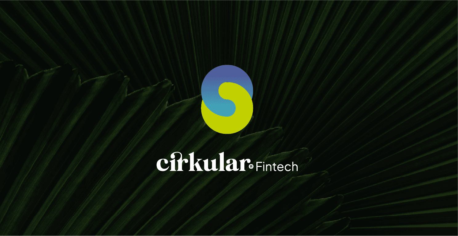 woman siting with coffie in her hand and the young men is standing looking at the camera