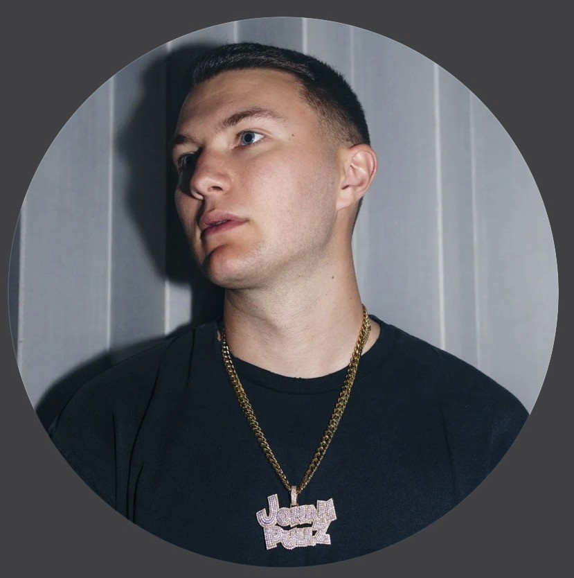 A person in a white shirt and sunglasses adjusts their cap, walking along a palm-lined sunny street. The mood is relaxed and tropical.