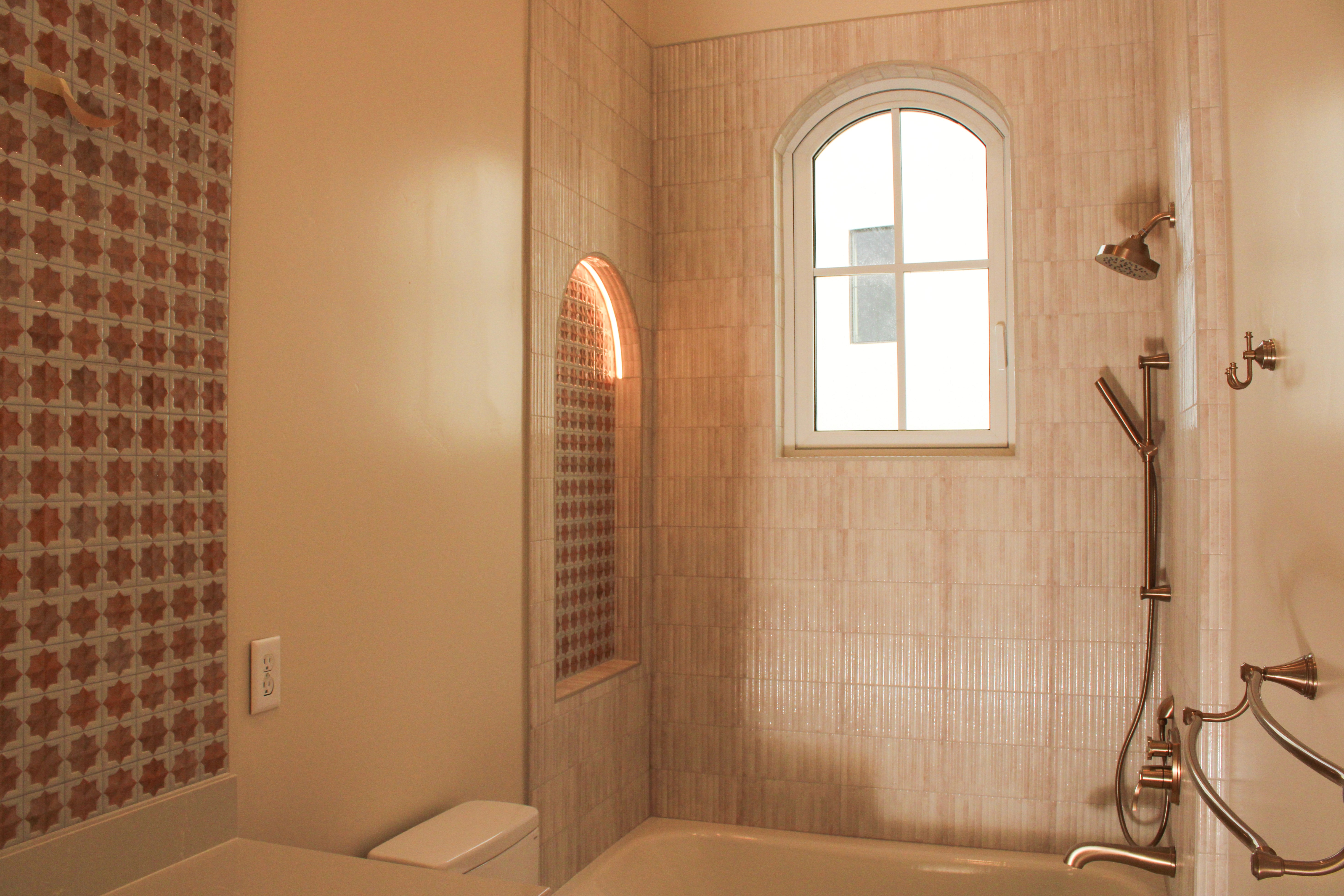 Secondary bathroom showcasing arched niches and contemporary tile design in a St. George, Utah custom home.