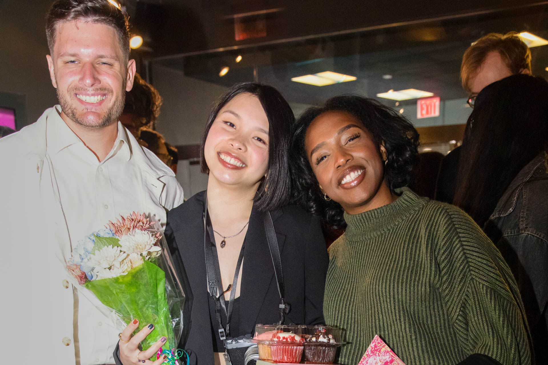 a group of students smiling for the camera in the SVA Theatre lobby after the Venture Forum