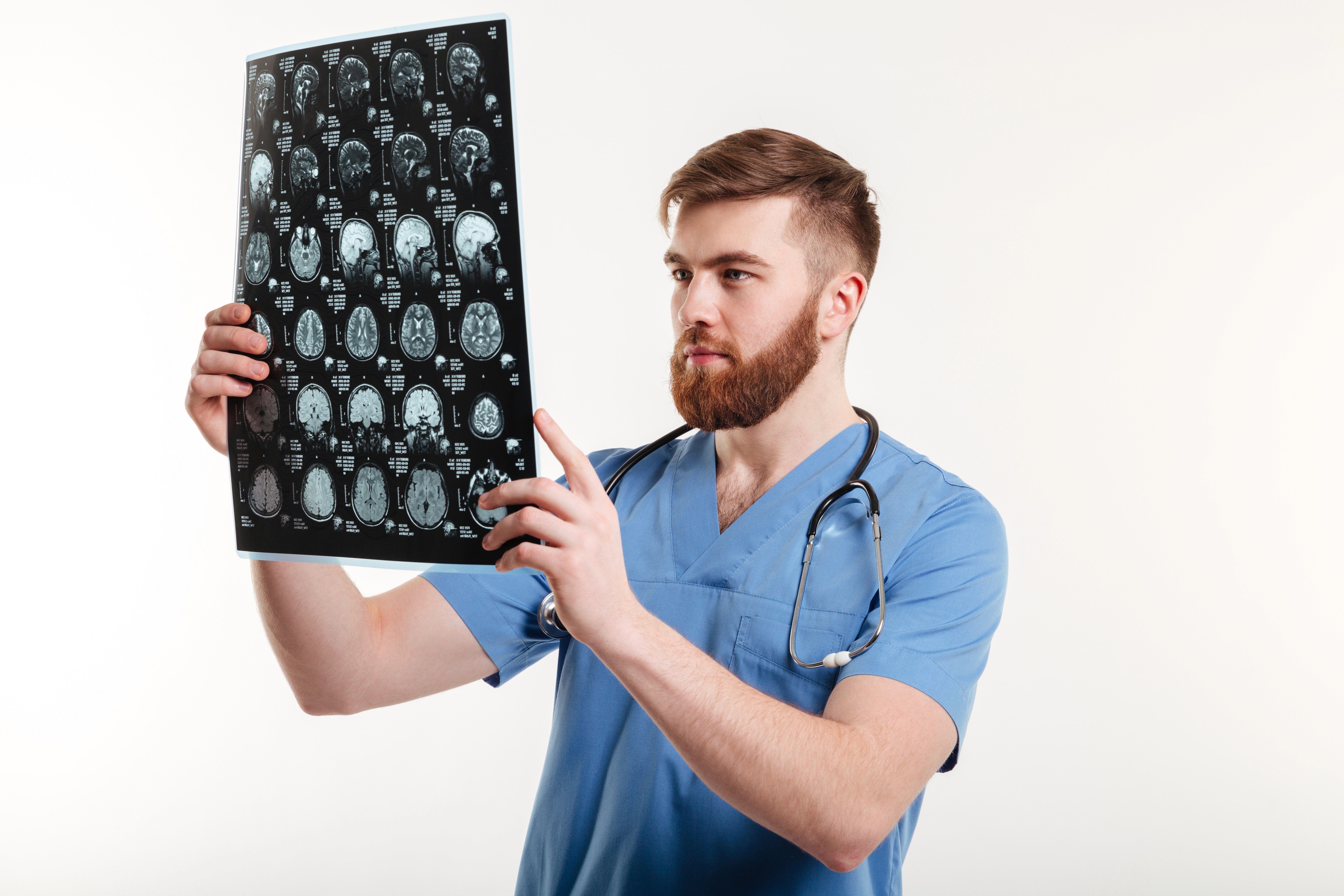 A nurse viewing MRI images and brain scans.