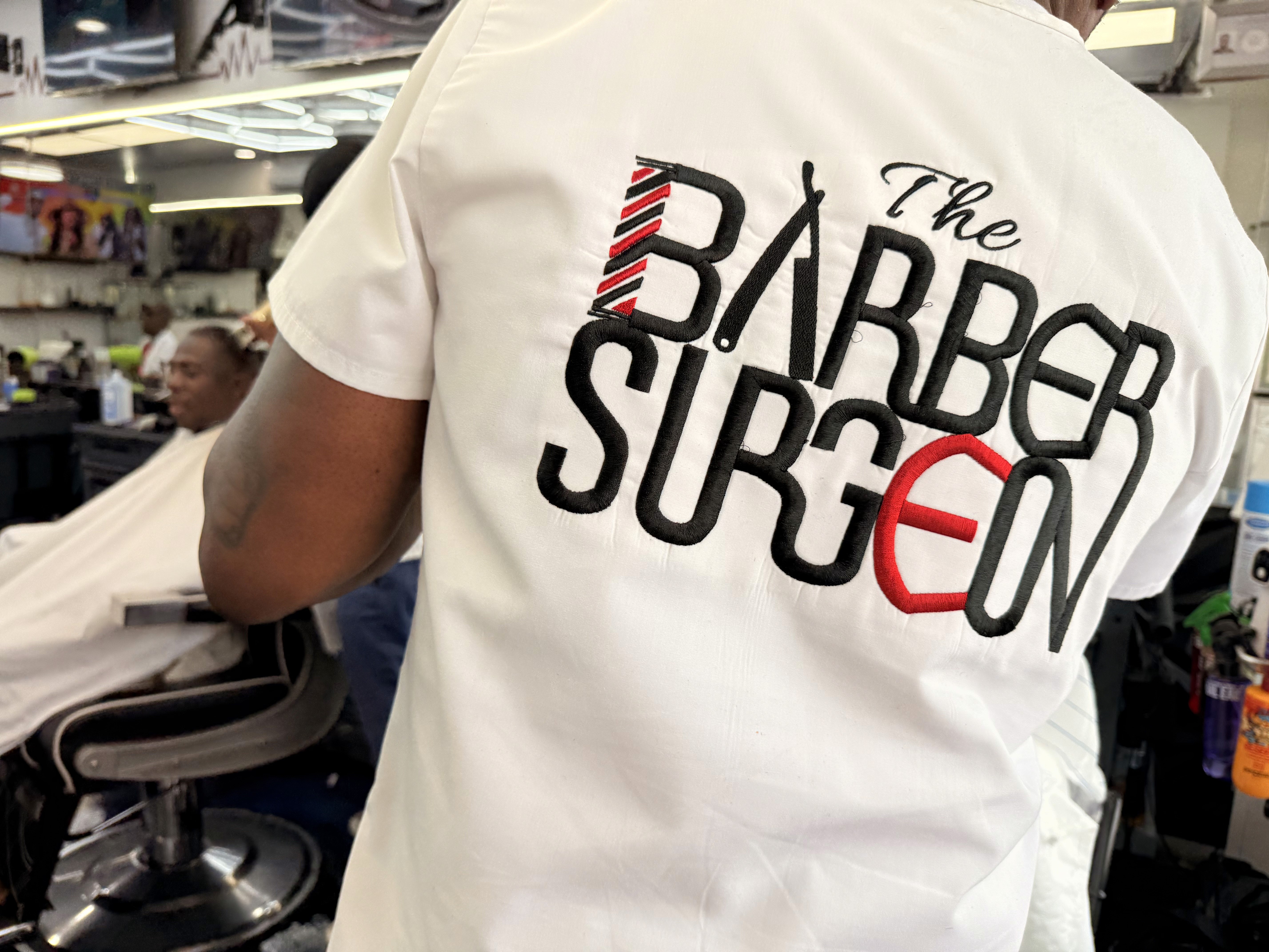 Barber relaxing and talking with client