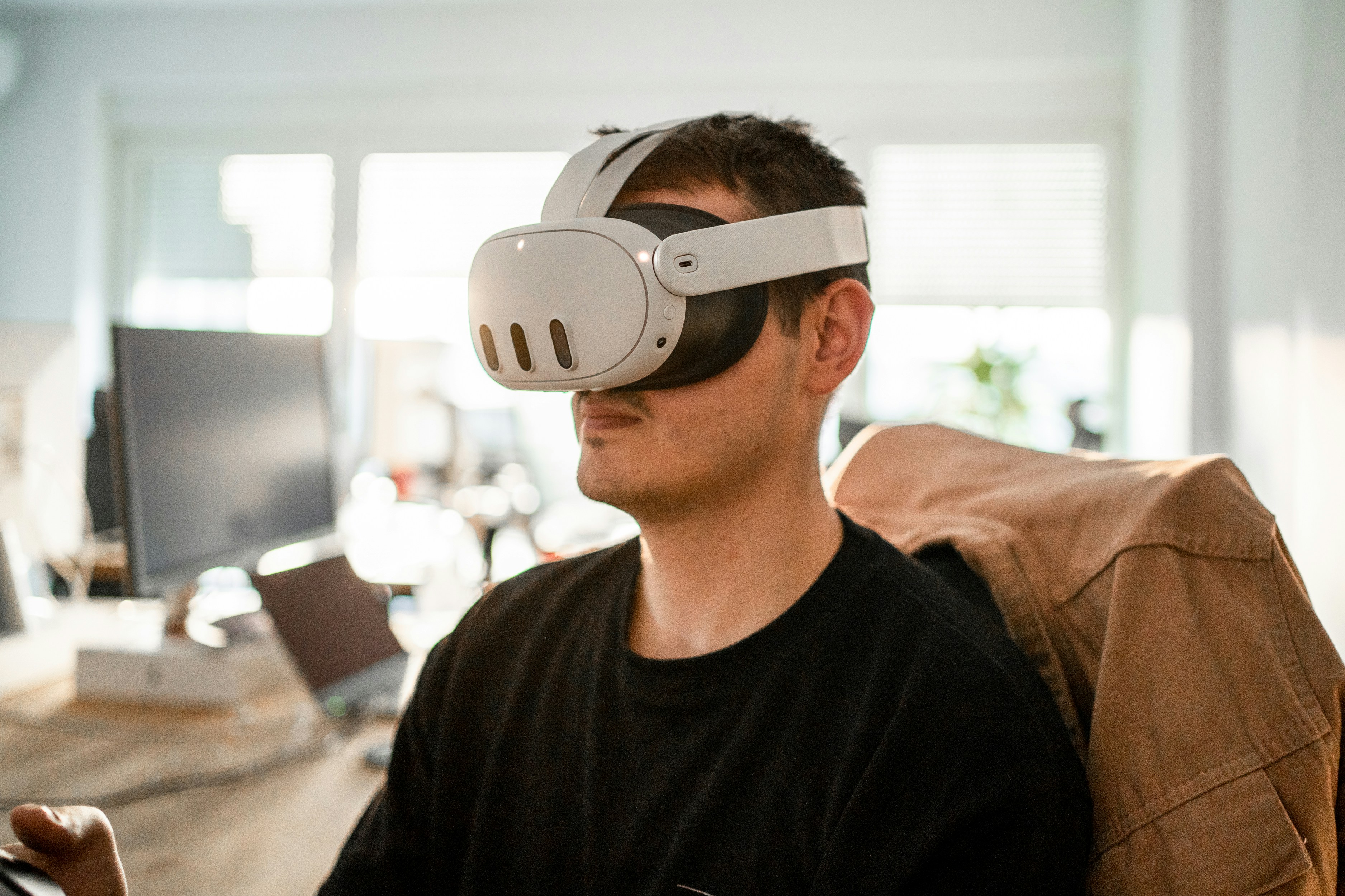 This image shows a man using a meta quest 3 headset. The meta quest 3 might be the future of virtual and mixed reality.