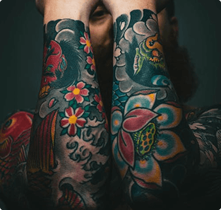 Man with elaborate full back and arm tattoos