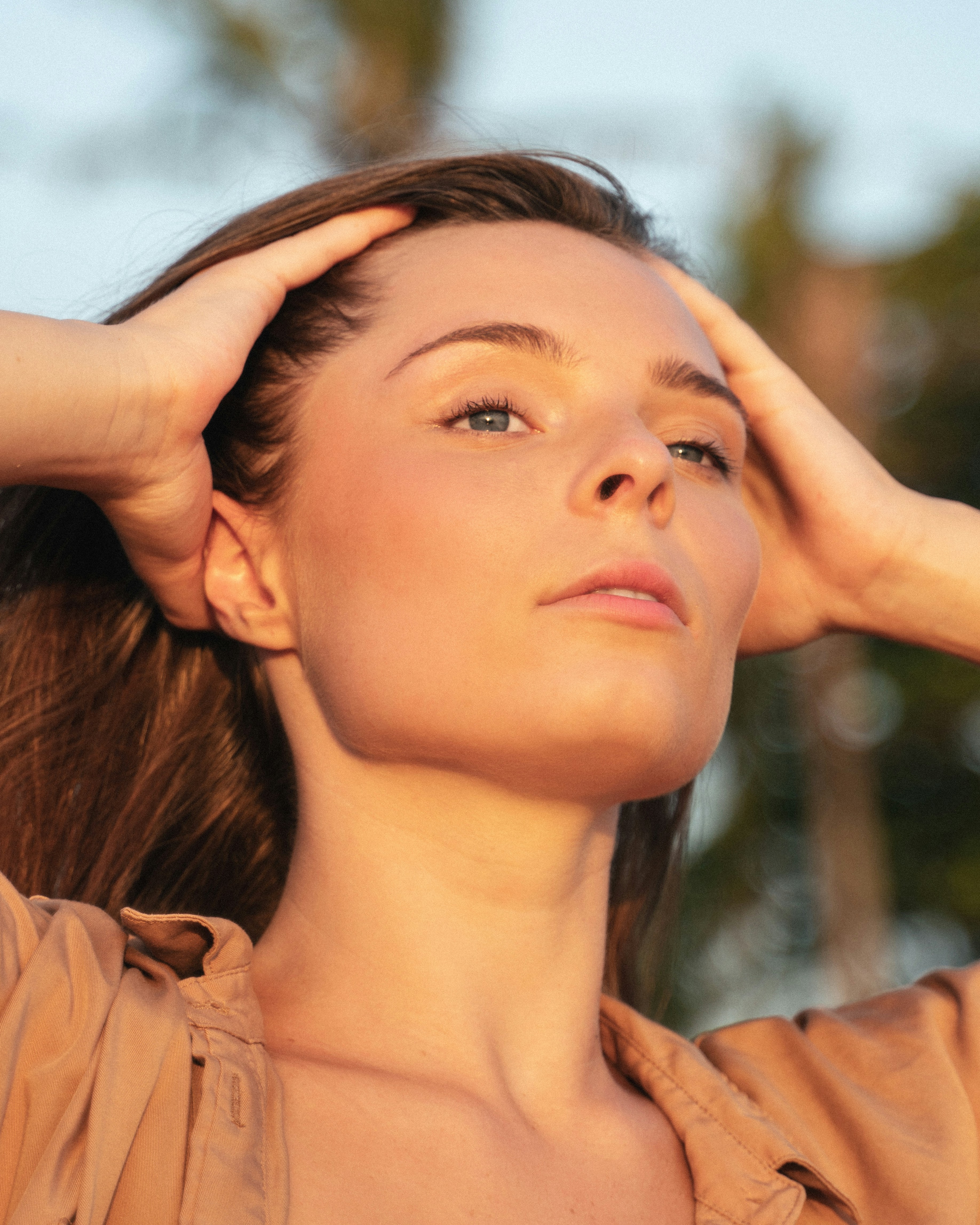 a woman with her hand on her head