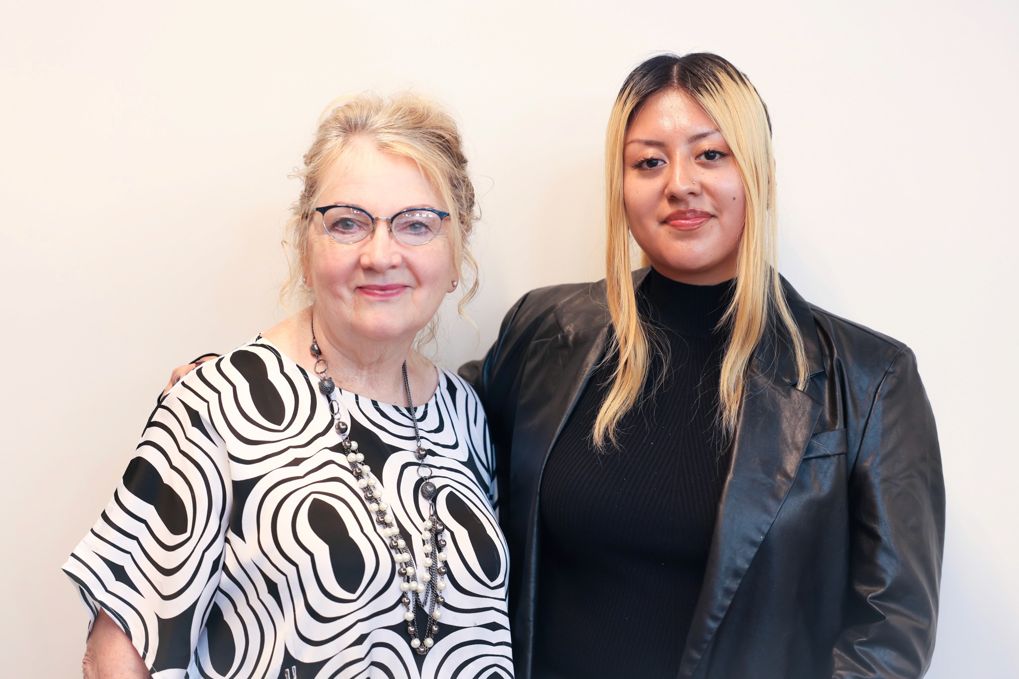 Student and College Admission Mentor standing side by side, smiling at the camera. 