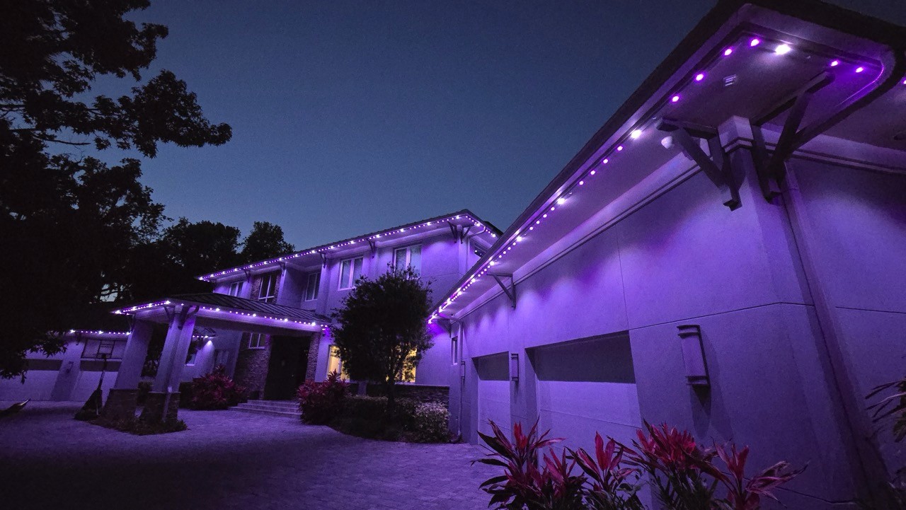 Permanent roofline LED lighting installed on home exterior with color-changing effects