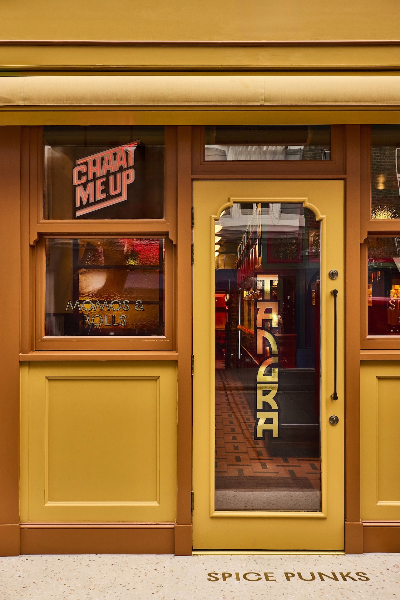 Vertical shot of the yellow shop front of Tangra