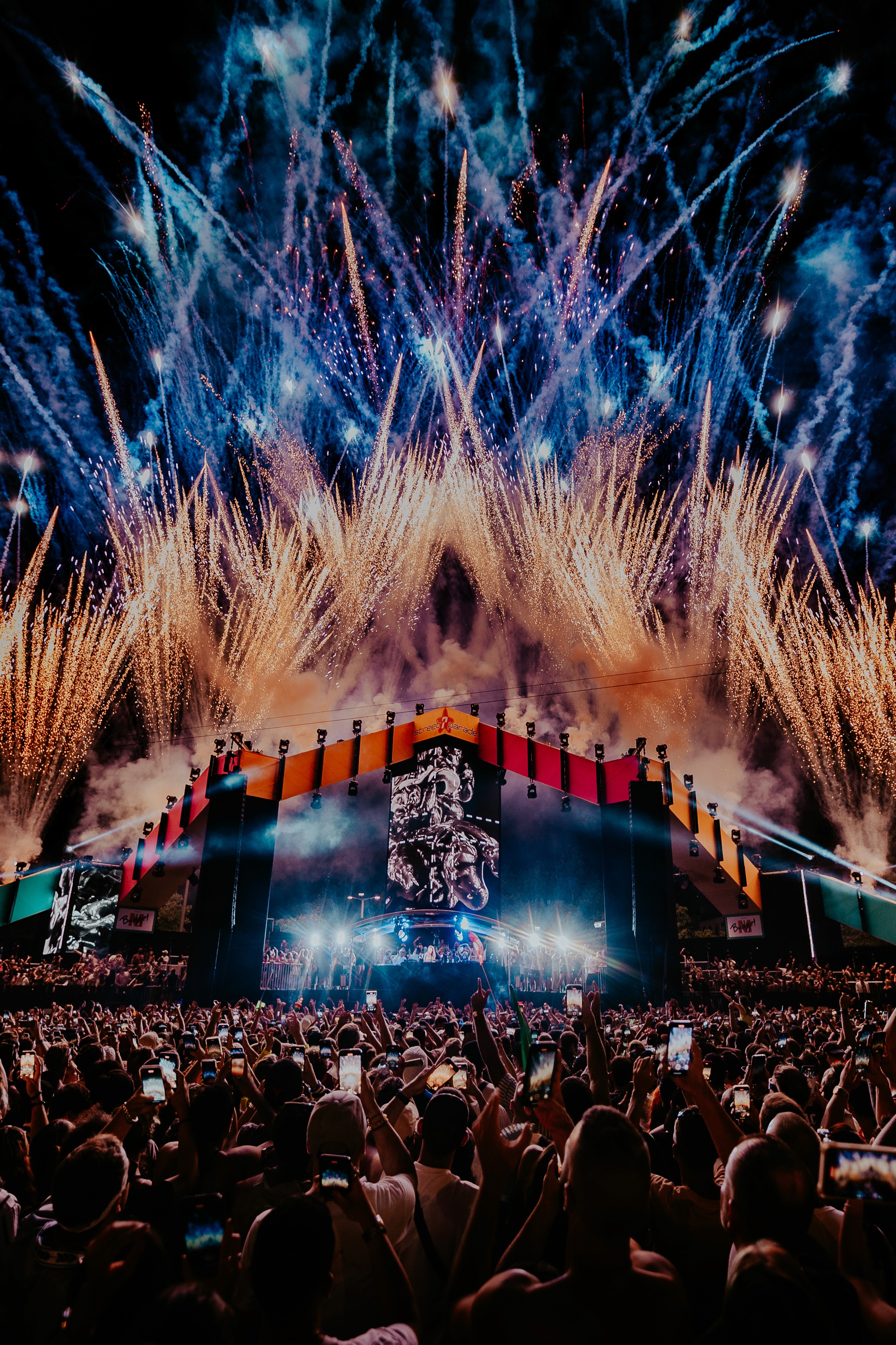 Green car under neon lights in a rainy city street