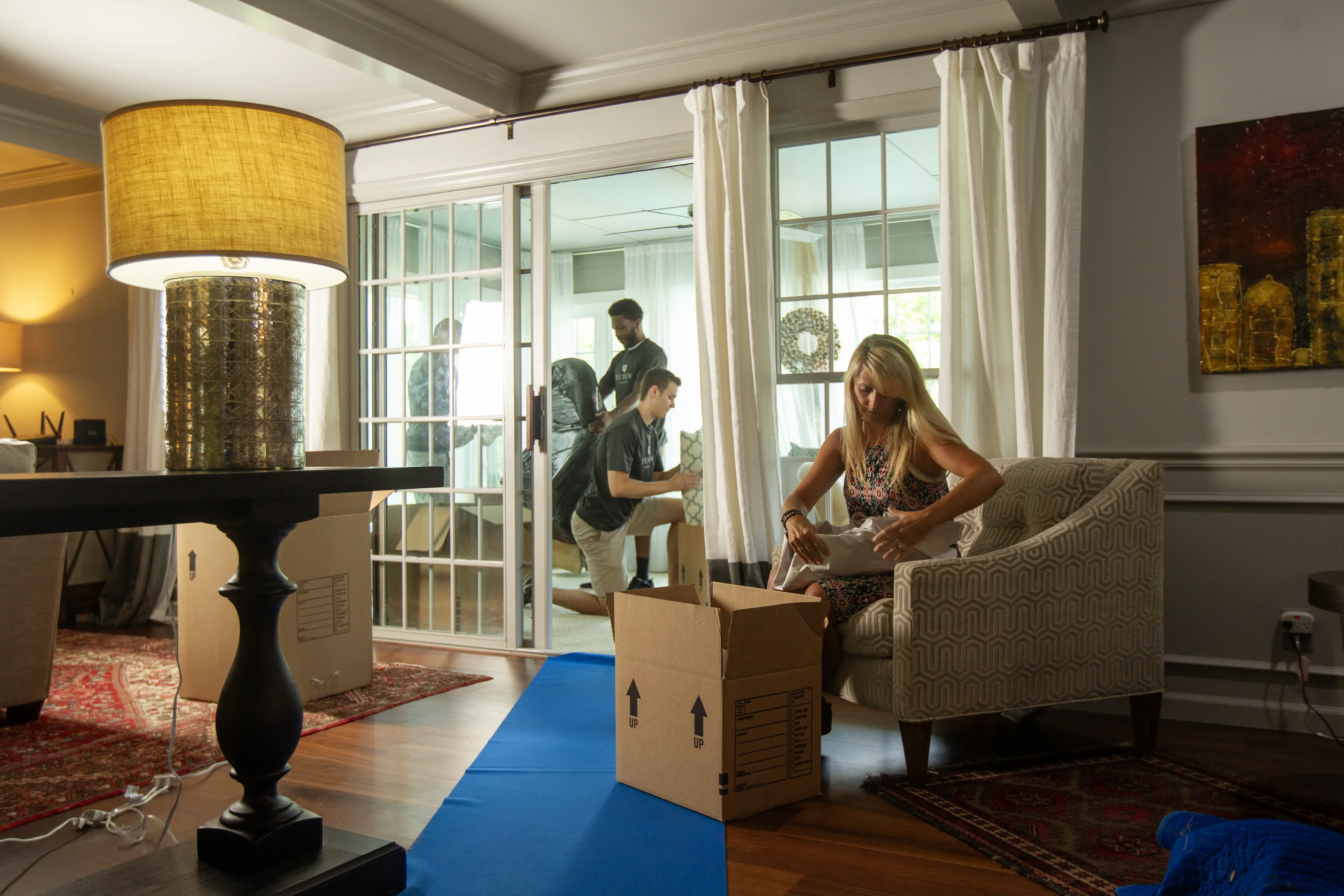 Professional packers meticulously wrapping and securing fragile items for move
