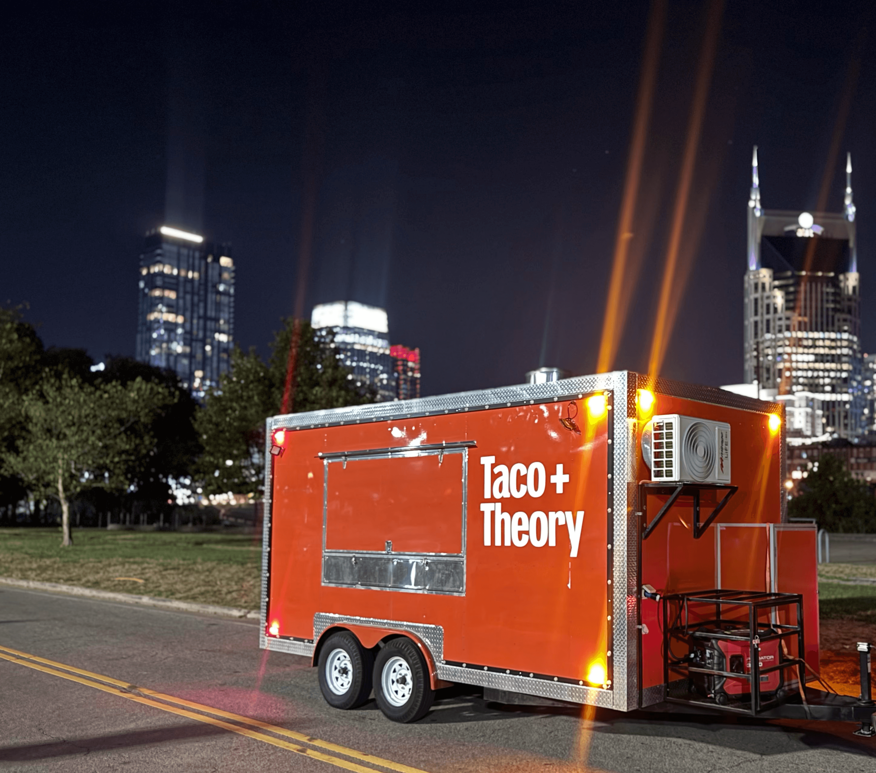 A rustic indoor scene featuring a table set for a meal, including two bowls of rice-based dishes topped with garnishes, an oil bottle, bread, a glass of juice, and milk bottles, all bathed in natural light streaming from a window.