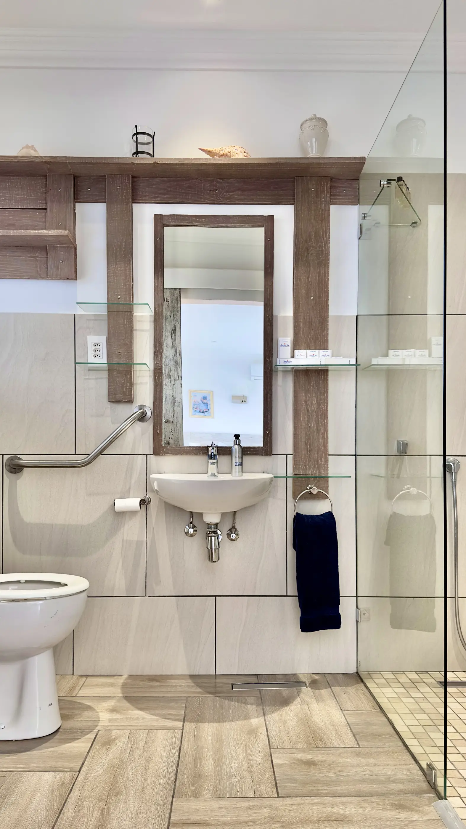 View of the bathroom sink, part of the toilet and shower in the 1 For All room at Somerset View Guest House.
