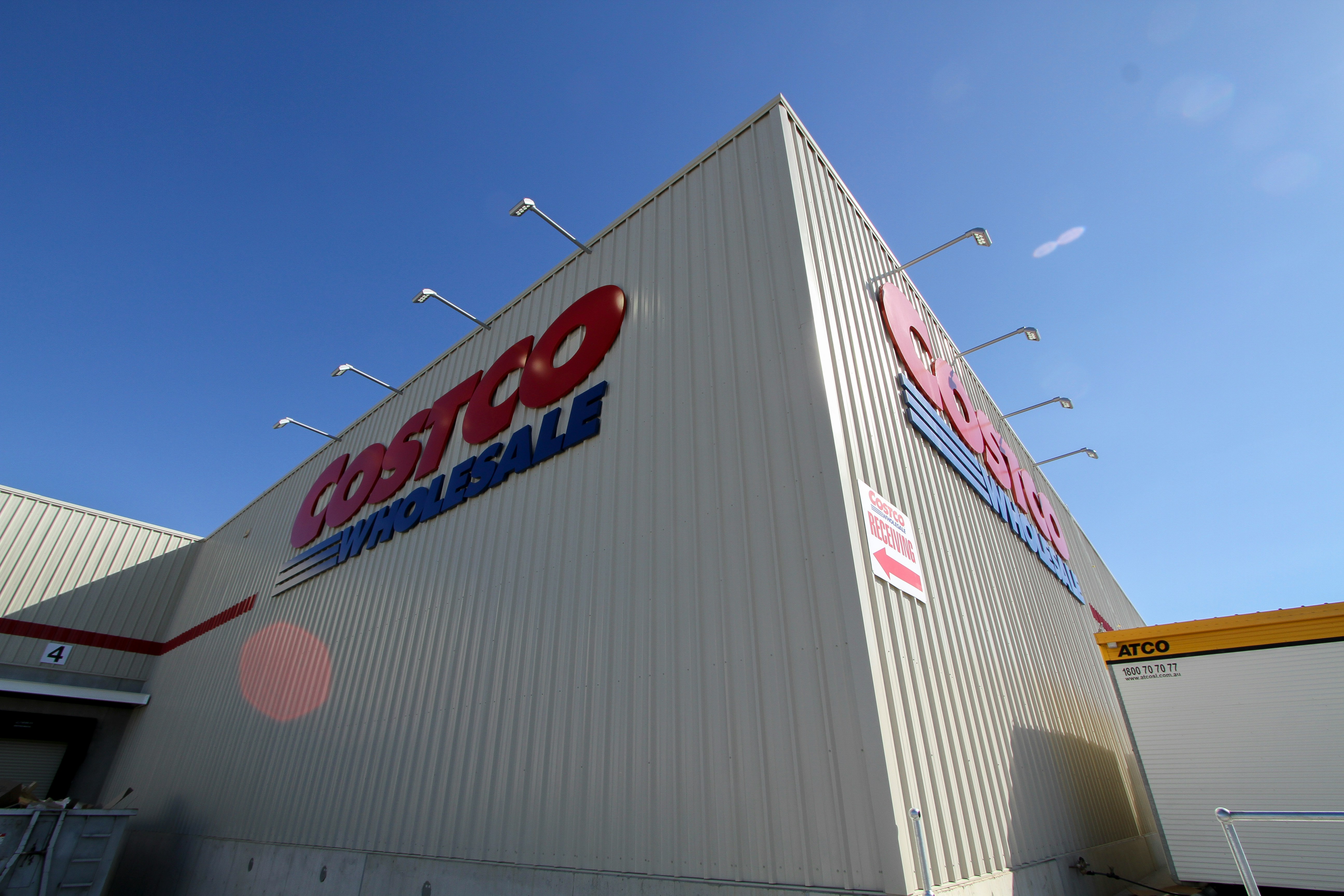 a large white building with a red and blue sign on it