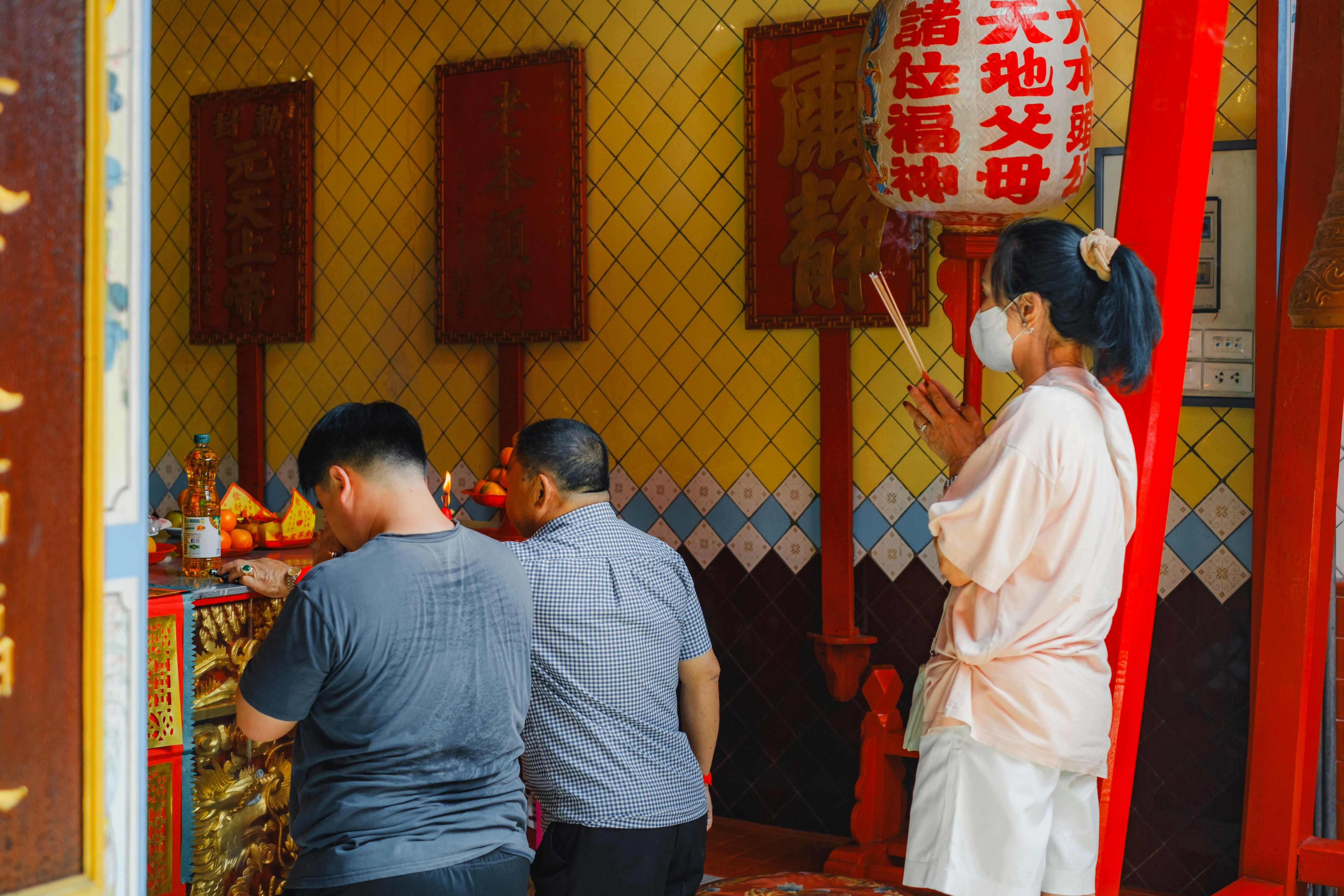 A group of people standing around a shrine