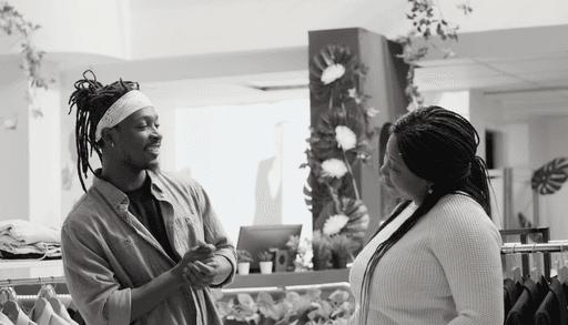 Man and woman engaging in conversation inside a store, representing verified trust, authentic relationships, and secure interactions with Profiled Nigeria.