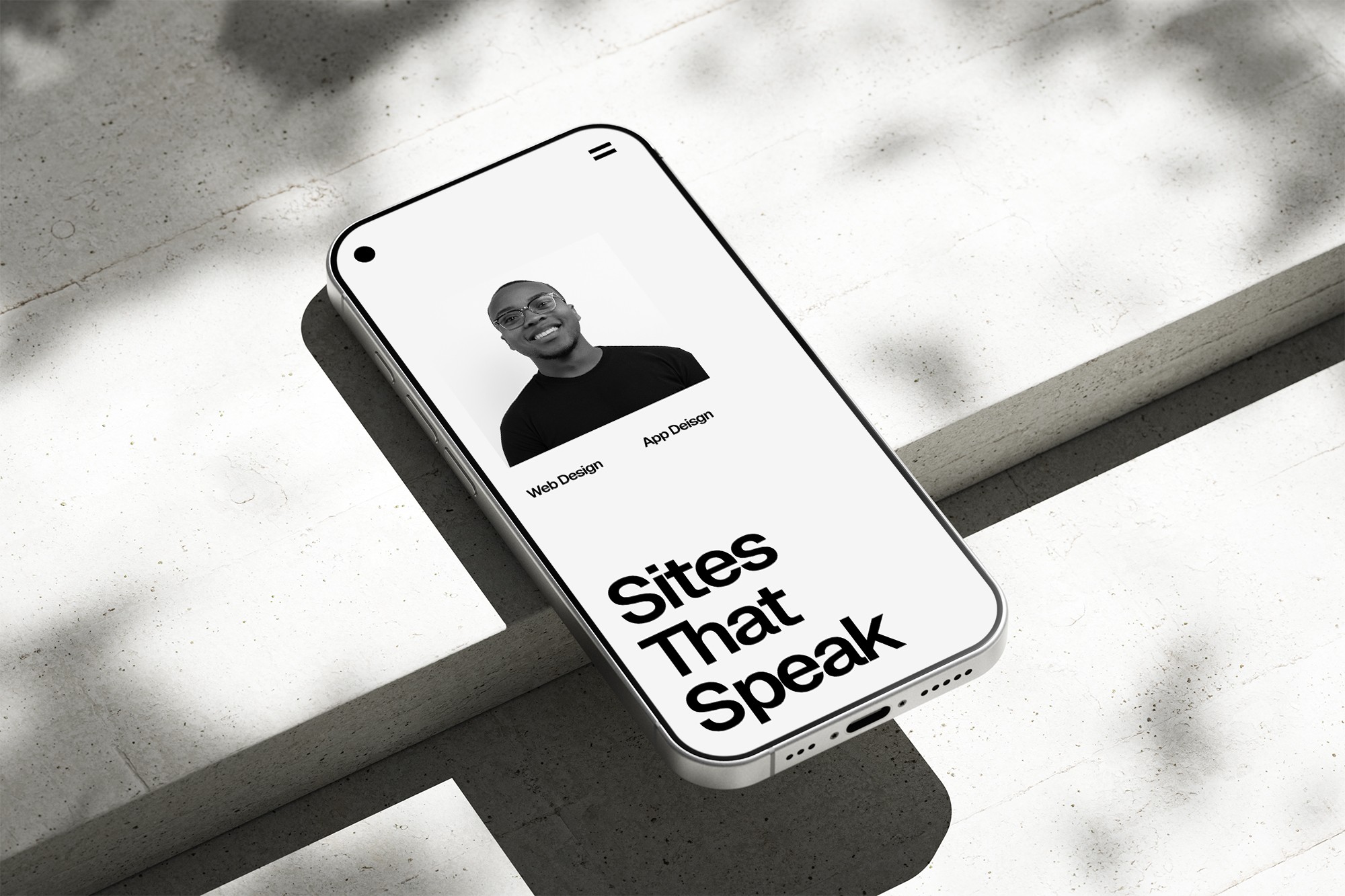 Phone on concrete, website on screen