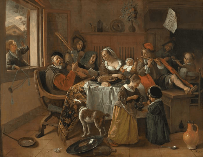 A lively group of people gathering around a table, playing music and enjoying each other's company in a cozy room.