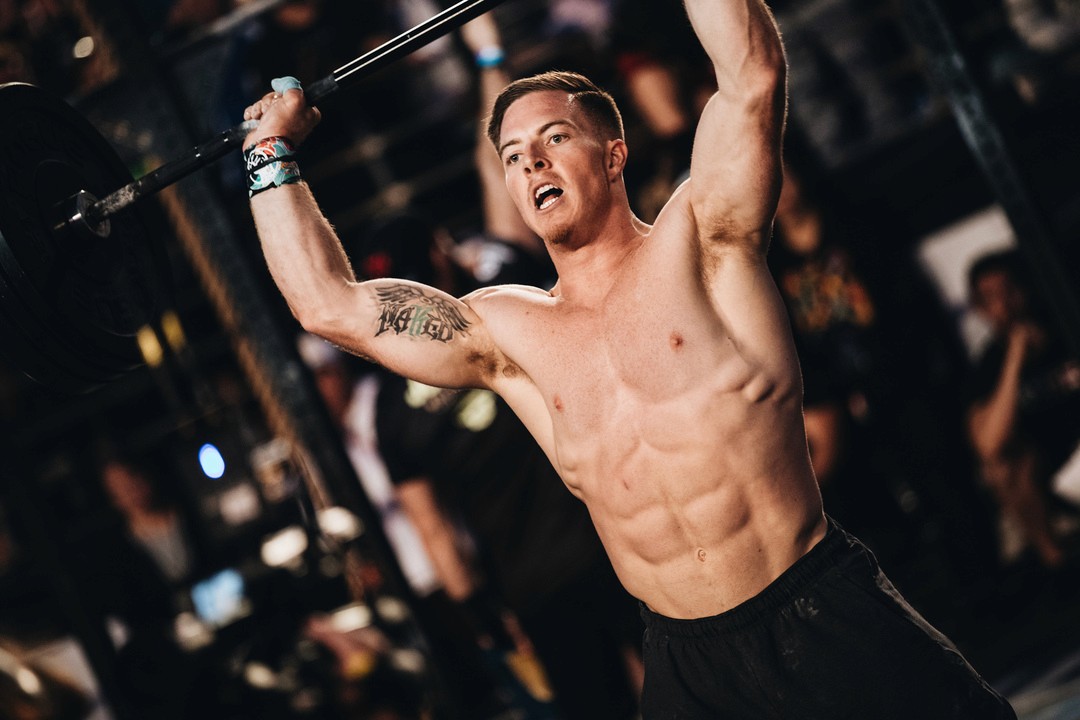 man lifting weight - Why Can’t I Straighten My Arm After Working Out