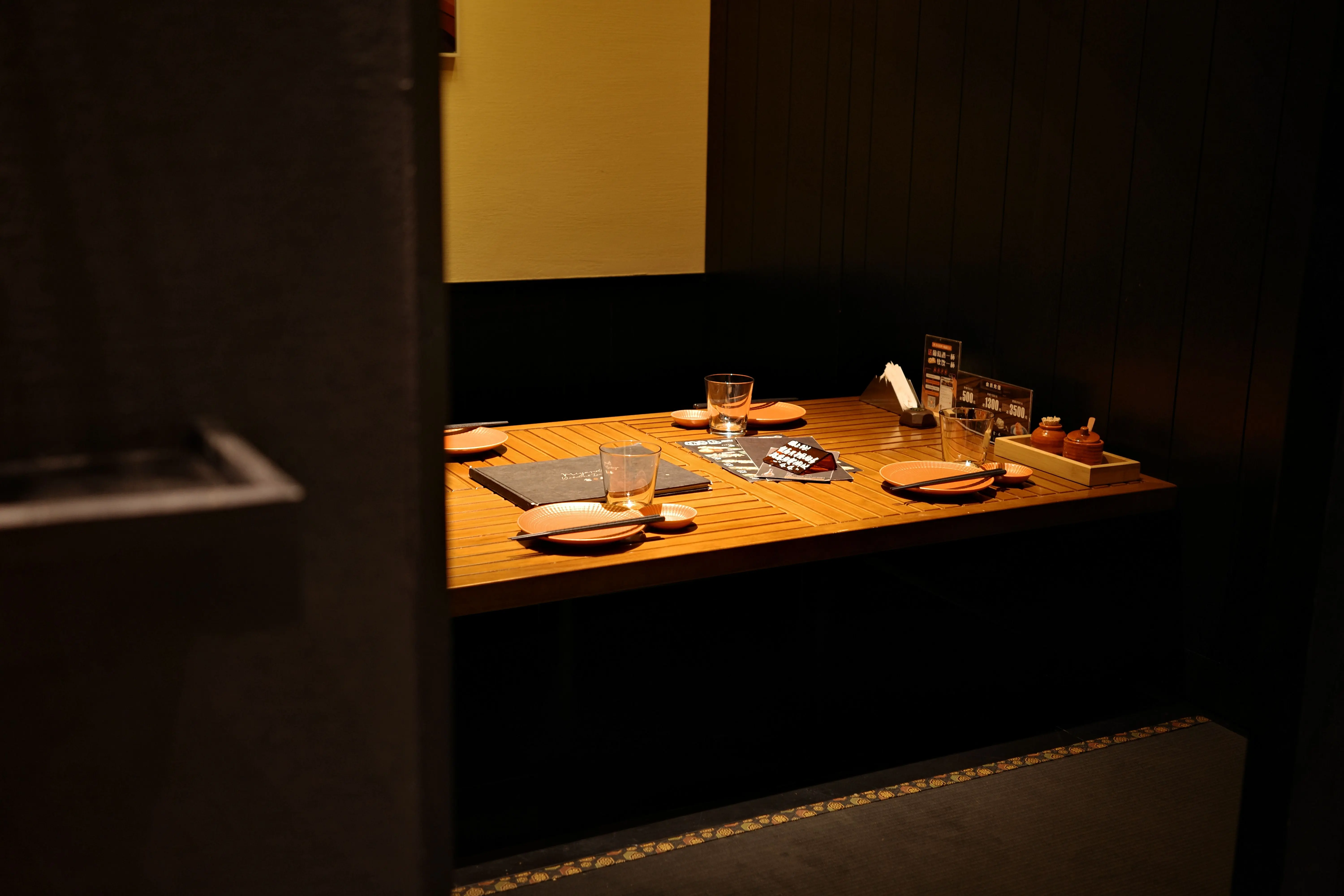Stacks of white dinner plates waiting in the quiet dining room