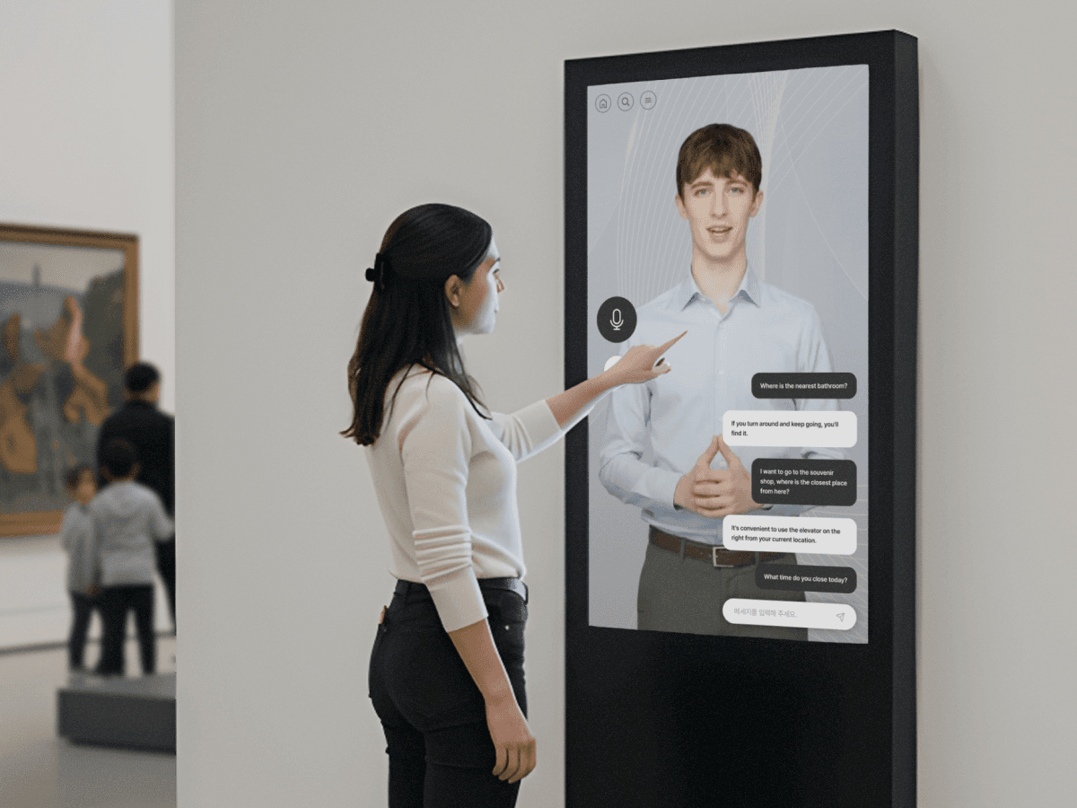 Four diverse professionals collaboratively working on a laptop, with one person pointing at the screen while others observe.