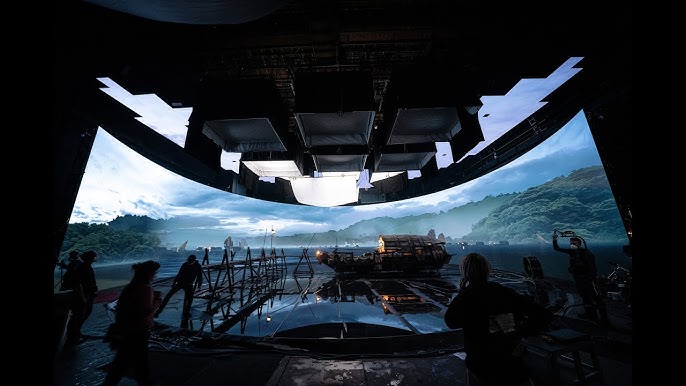 A panoramic view of a futuristic landscape with mountains and a sky, viewed from a high-tech control room.