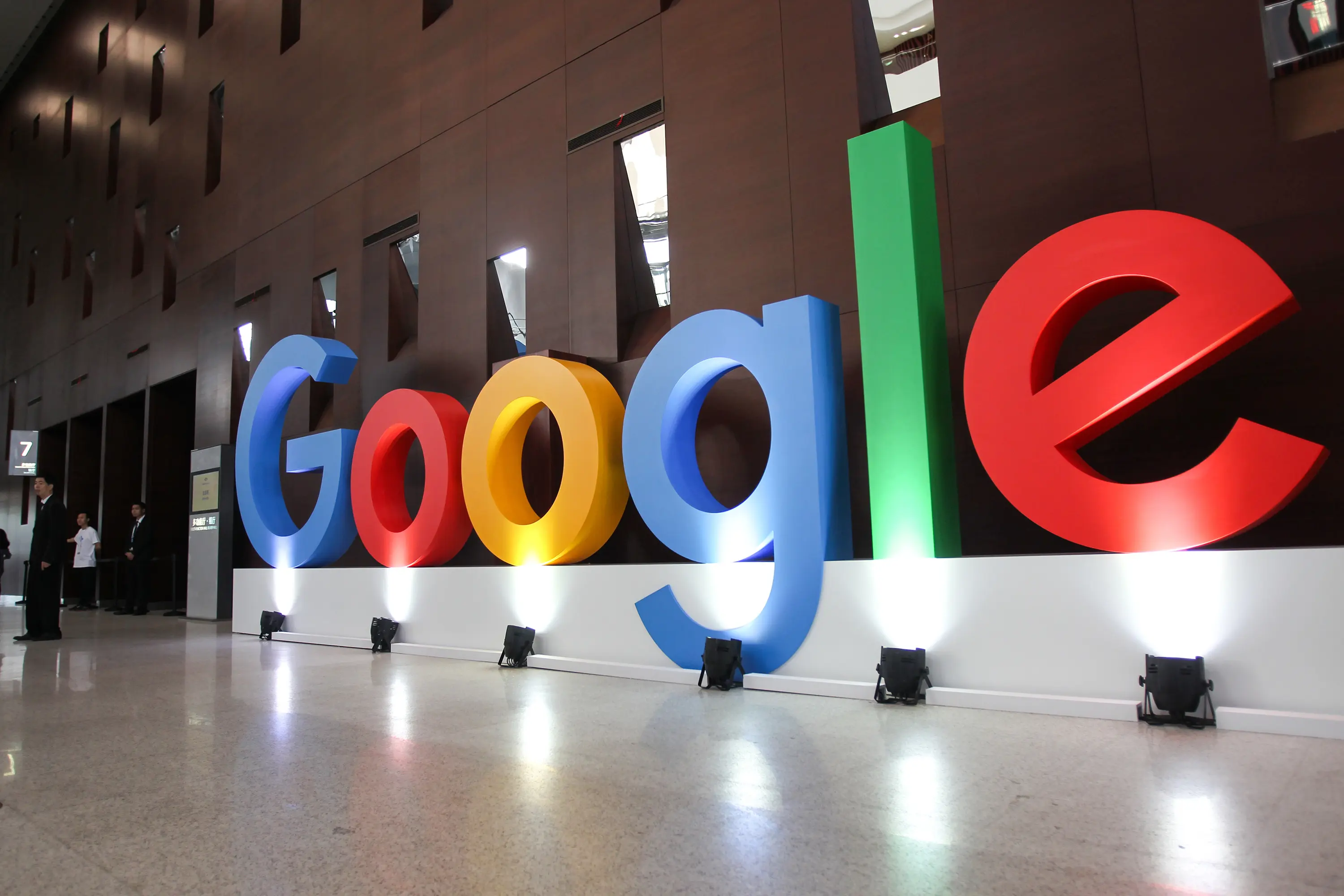 Google logo in vibrant colors displayed in a modern interior setting, highlighting Google's branding with large letters in blue, red, yellow, and green.