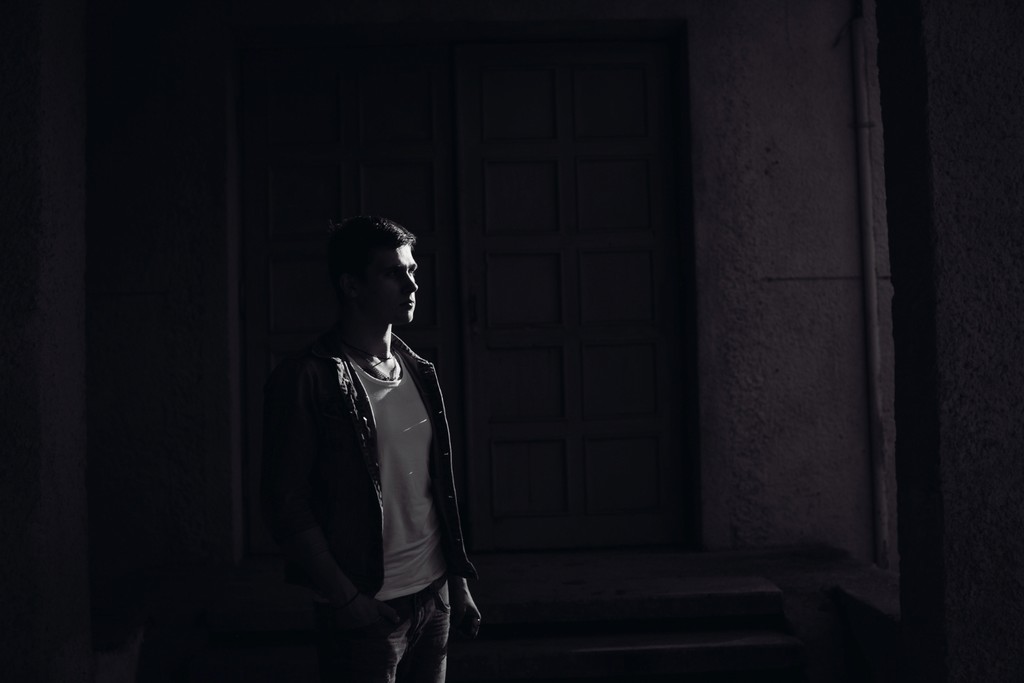 Black and white portrait of a smiling person with curly hair