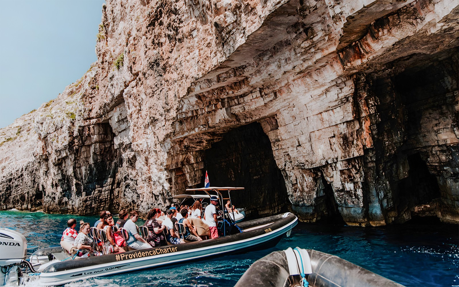 Speedboat tour entering Blue Cave on Blue Lagoon & 5 Islands trip.