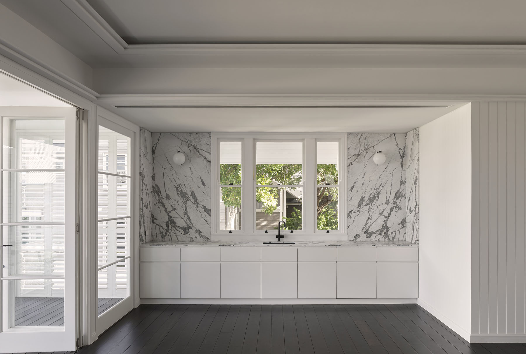 interior with marble splashback, built-in cabinetry and central window