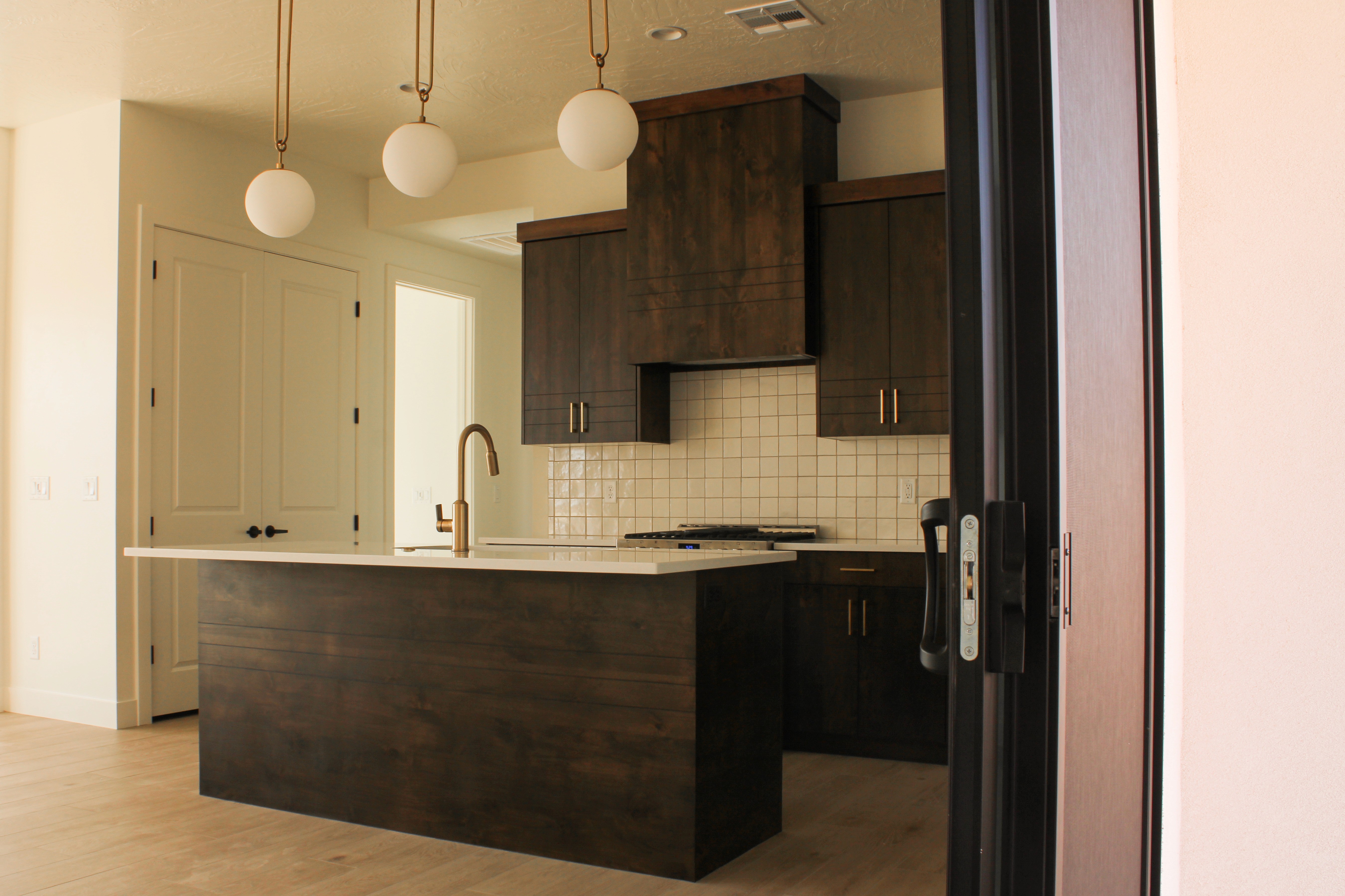 Kitchen of The Overlook at Falcon Ridge, Hurricane, Utah, highlighting cabinetry, countertops, and natural light.