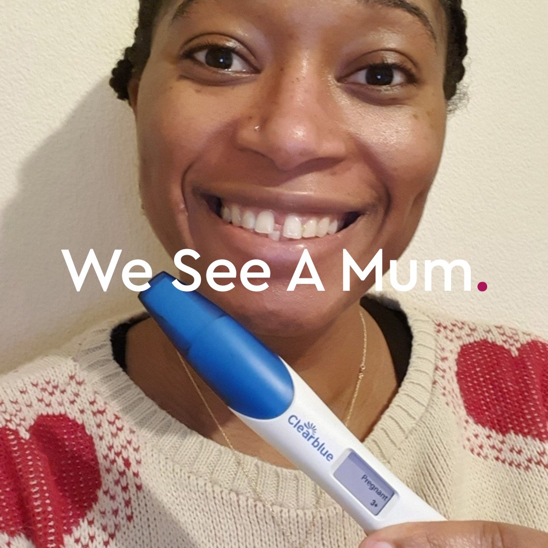 A womon holding a positive pregnancy test