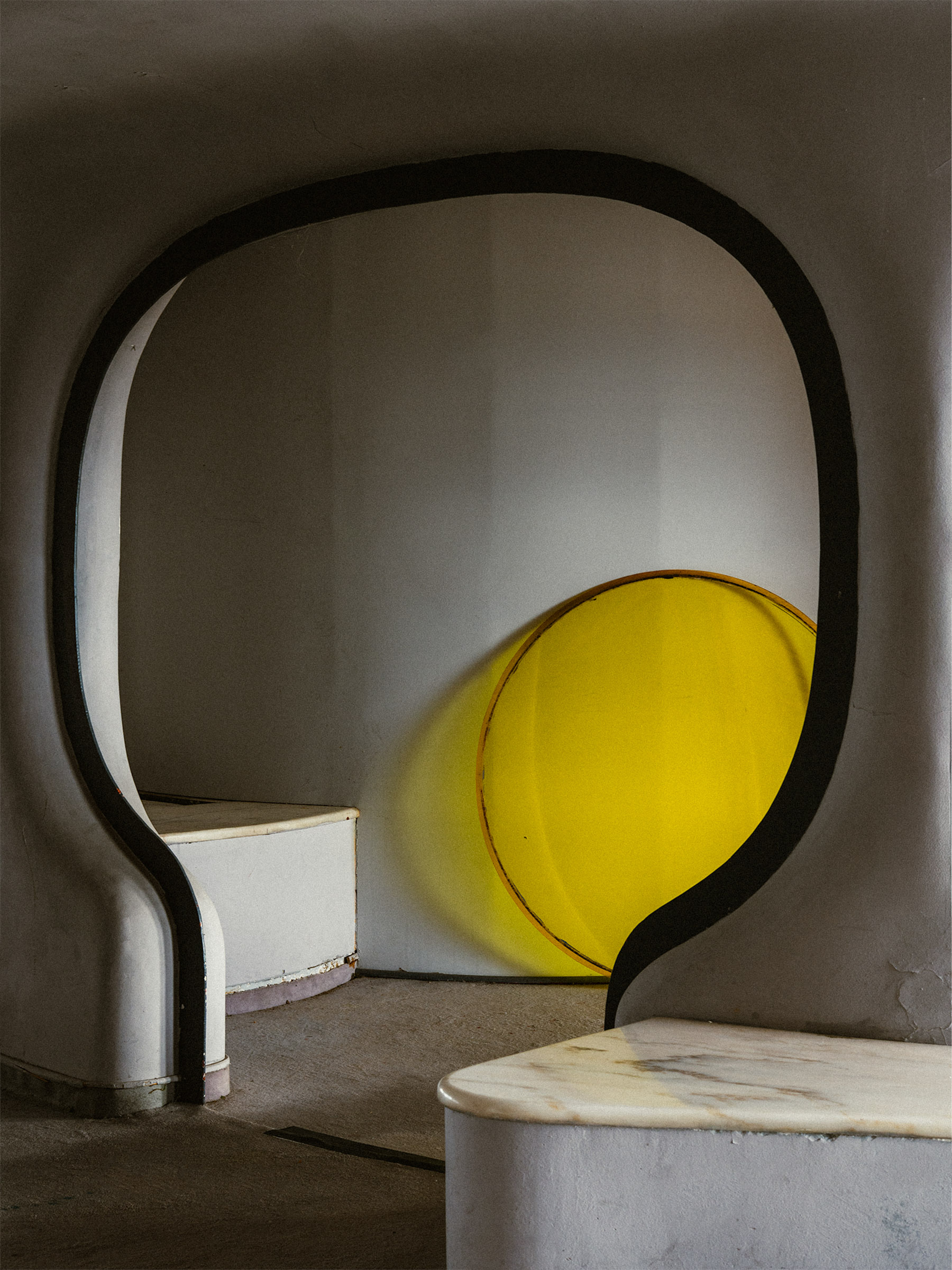 Interior of the 22nd floor of Torres Blancas in Madrid, featuring a sculptural opening and a yellow spherical object.