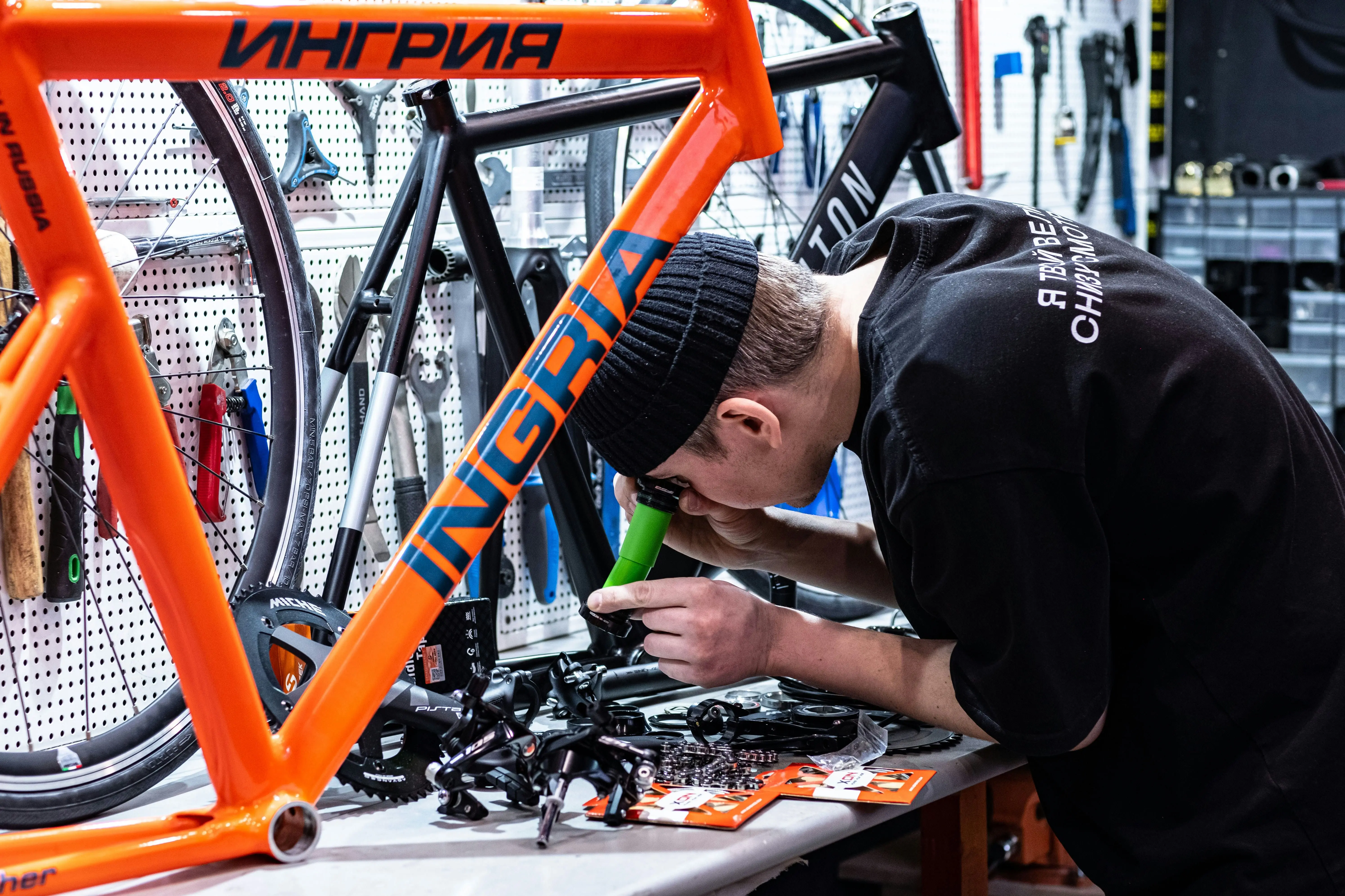 Close-up of bicycle frame repair and assembly in Chrome workshop