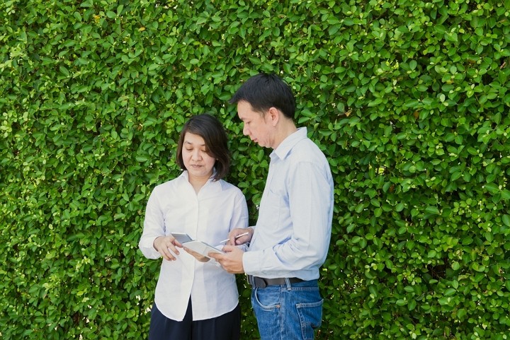 Business professionals discussing ESG strategy using a tablet