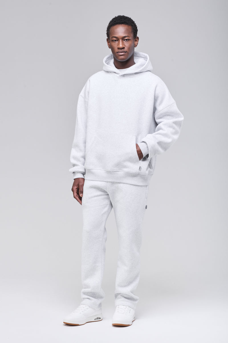 Male model wearing grey heavyweight boxy hoodie, full figure