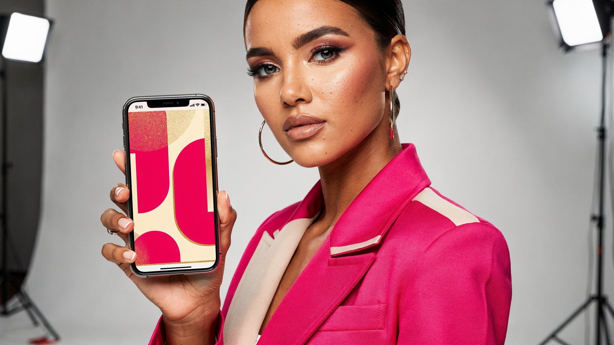 Fashion creator holding a phone displaying a tall vertical 4:5 Instagram feed post