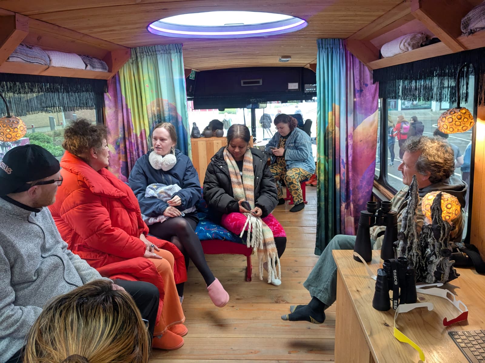 Hertfordshire staff and students inside the bus with colourful interior