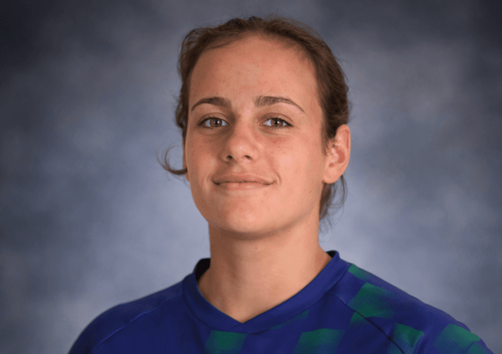 smiling woman wearing white and black pinstriped collared top