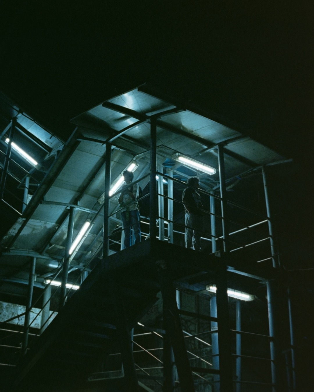 a blurry photo of a person standing in front of a wall