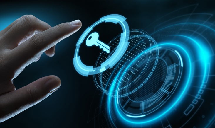 A person walks in front of large stone arches with dark doors, flanked by tall columns, in a historic building.