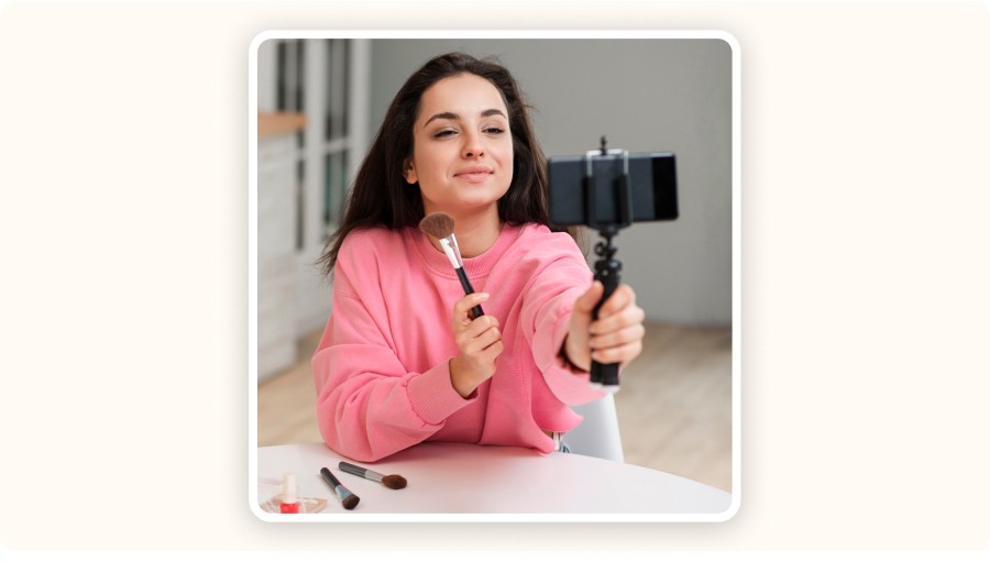 Young woman filming a makeup demo