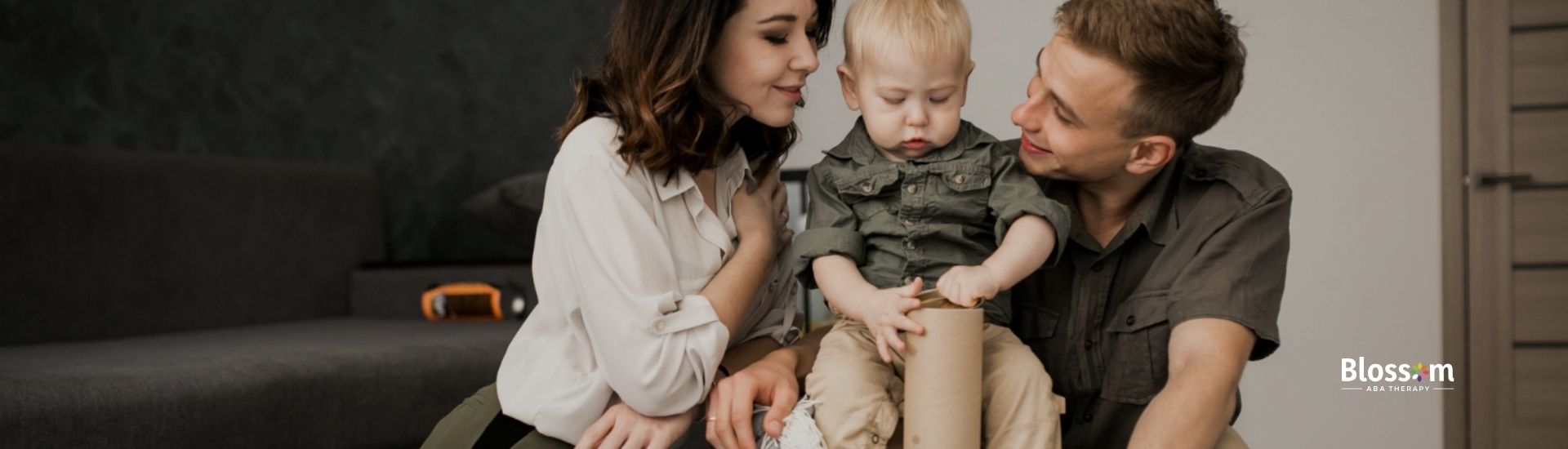 Parents playing with their autistic toddler on the floor.