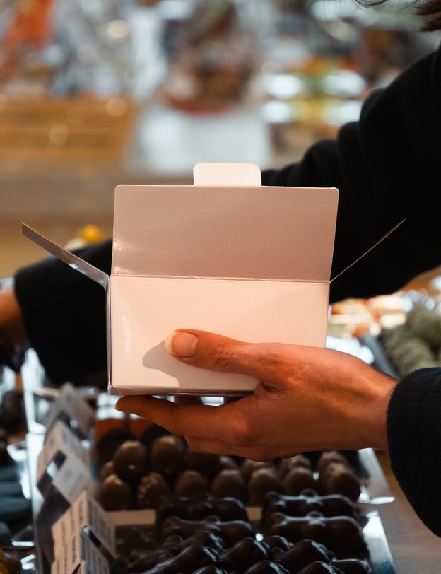 Collaboratrice préparant une boîte de chocolat - photo.