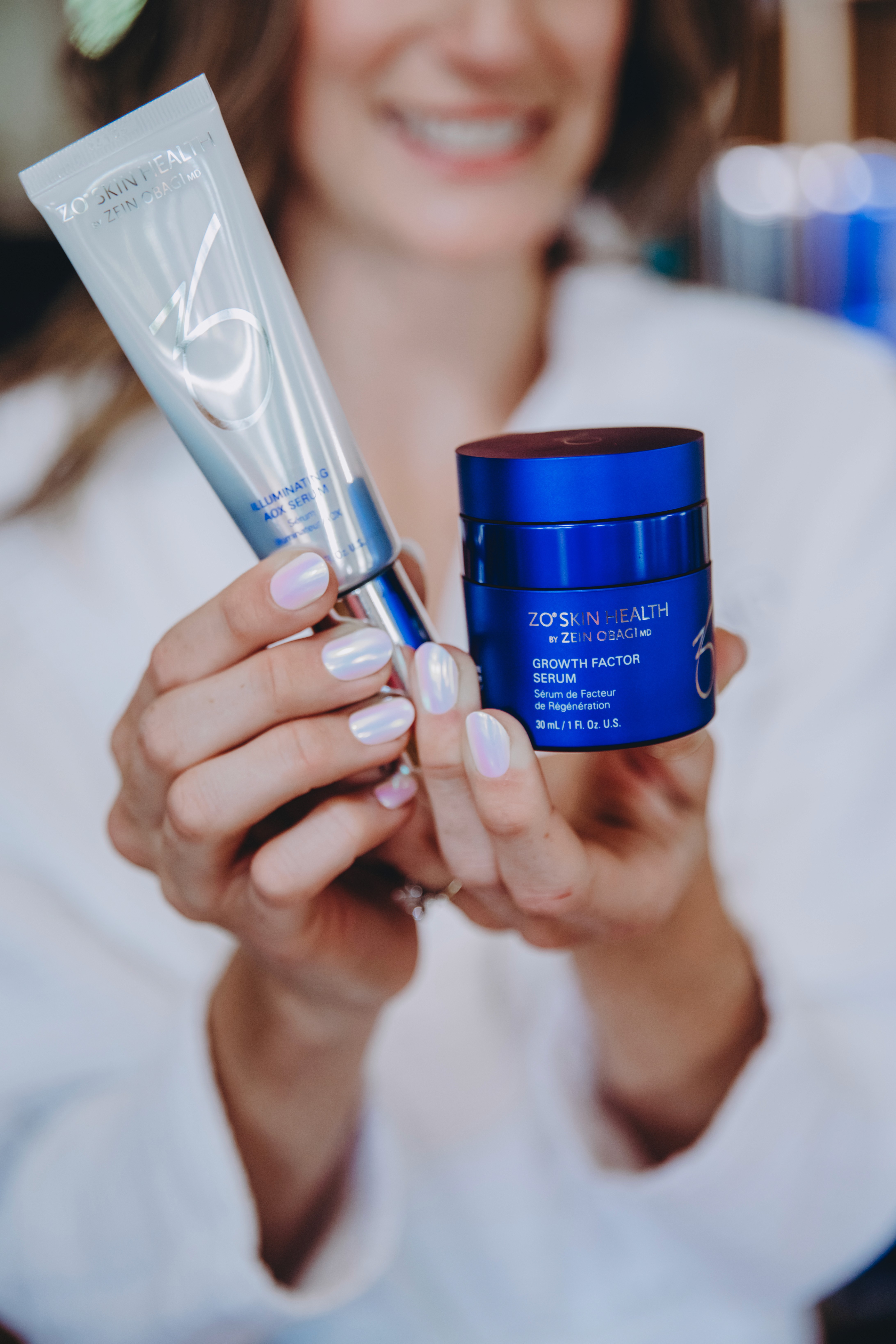 ZO Skin Health products held in front of a smiling client