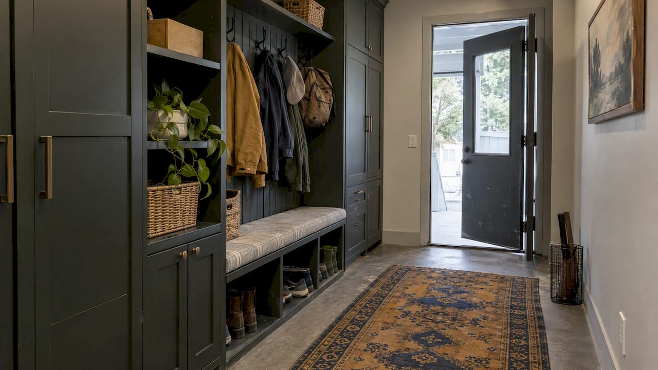Durable stylish mudroom with dark cabinetry