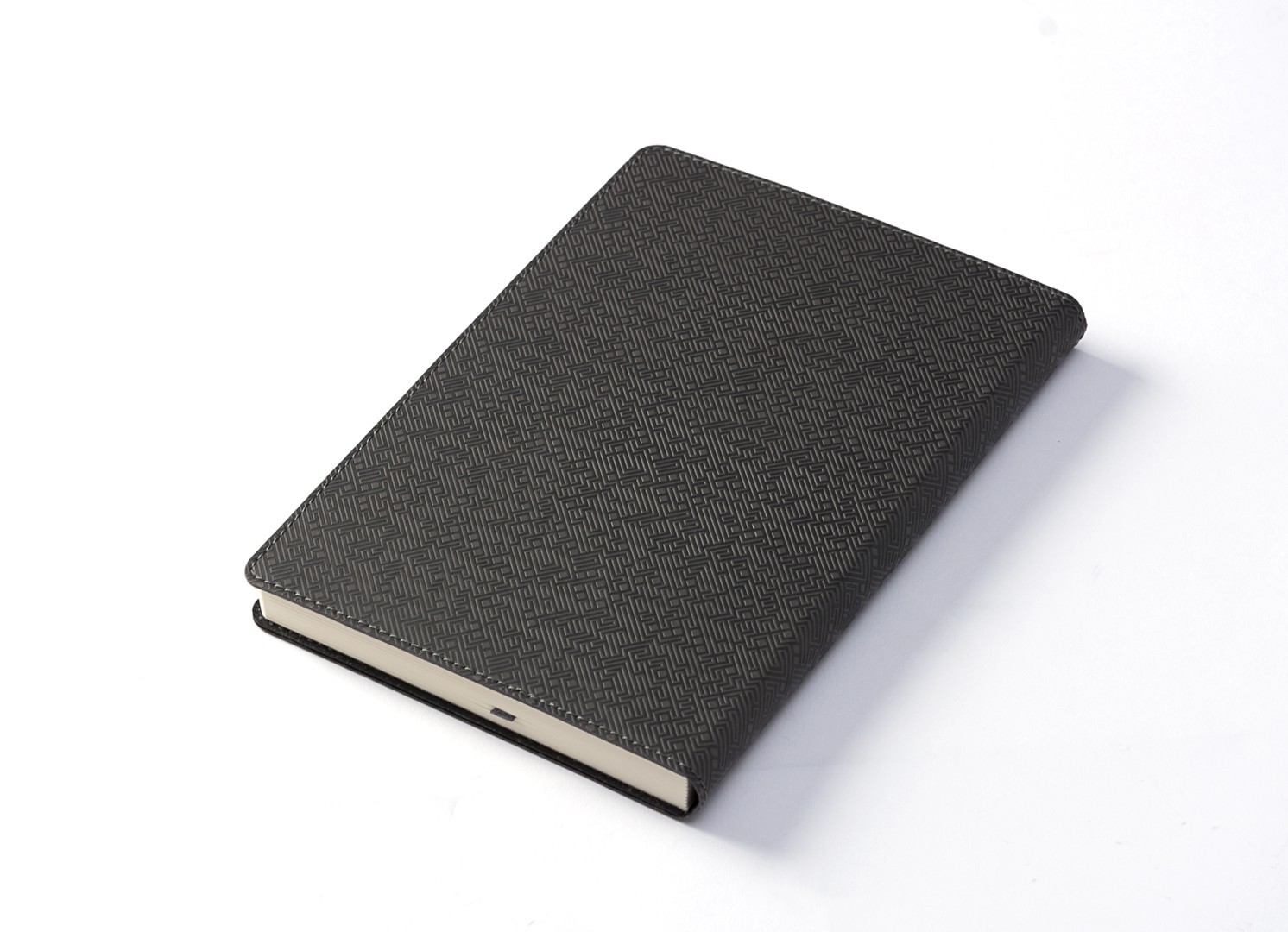 Back angled view of closed notebook showing consistent geometric texture.