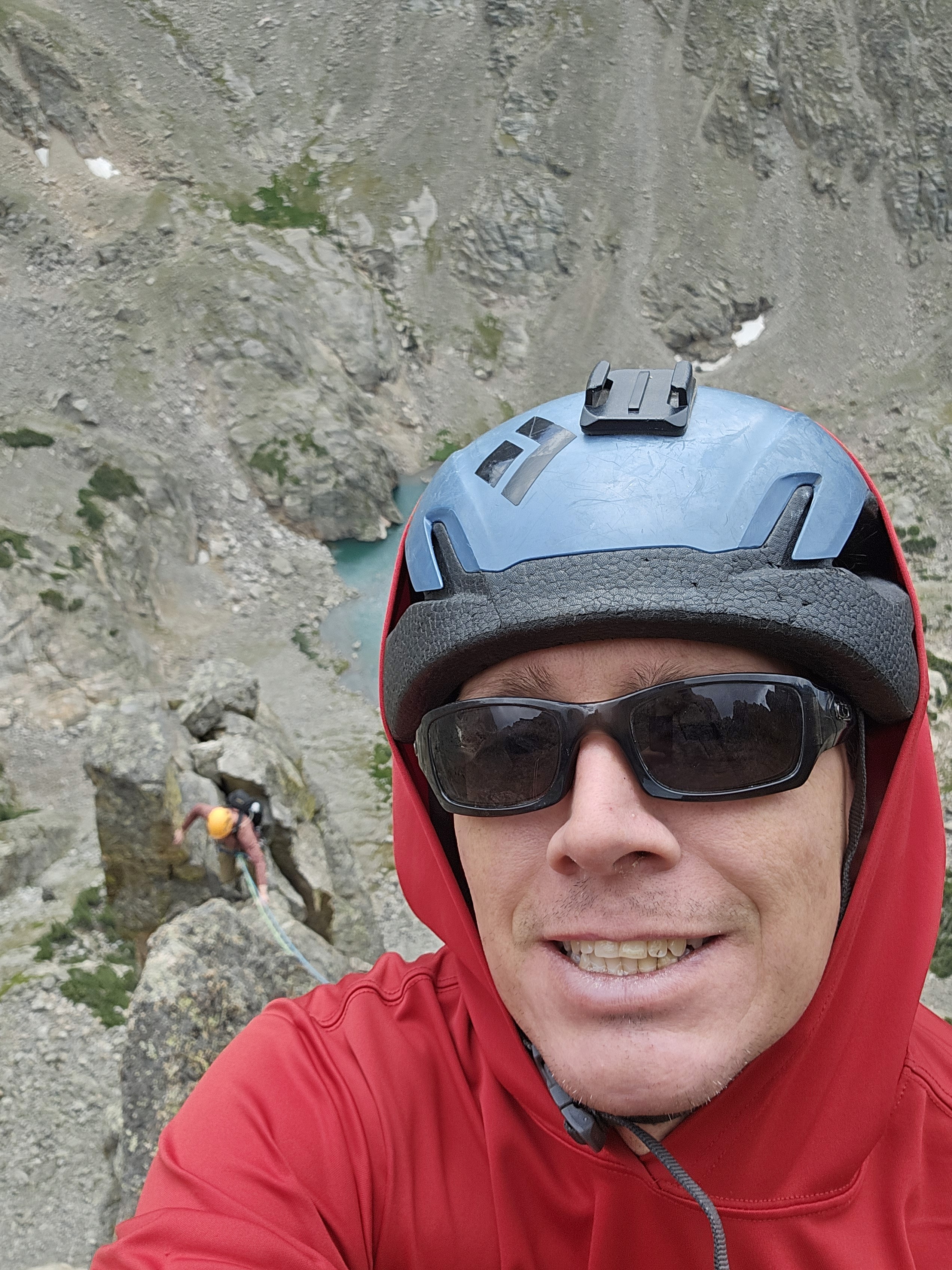 Guide smiles as client is following on south face of petit grepon