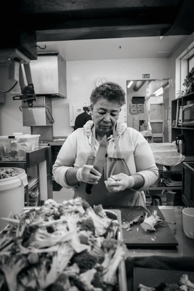 Volunteer preparing vegetables in the Compassion Soup Kitchen